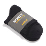 A black alpaca ankle sock in a Noble Alpaca Socks paper band, photographed on a white background.