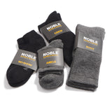 The four Noble alpaca sock styles, crew, ankle, boot and no-show, in black and grey with Noble paper bands