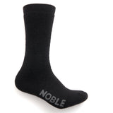 A black alpaca boot sock with the Noble logo on the sole, shown upright on a white background.
