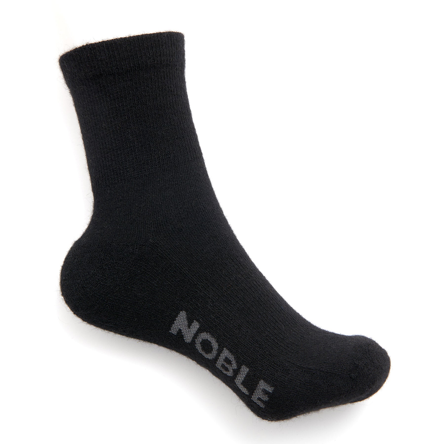 A black alpaca crew sock with the Noble logo knitted into the sole, shown on a white background.