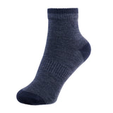 A navy merino wool ankle sock with cushioned heel and toe, shown on a white background.