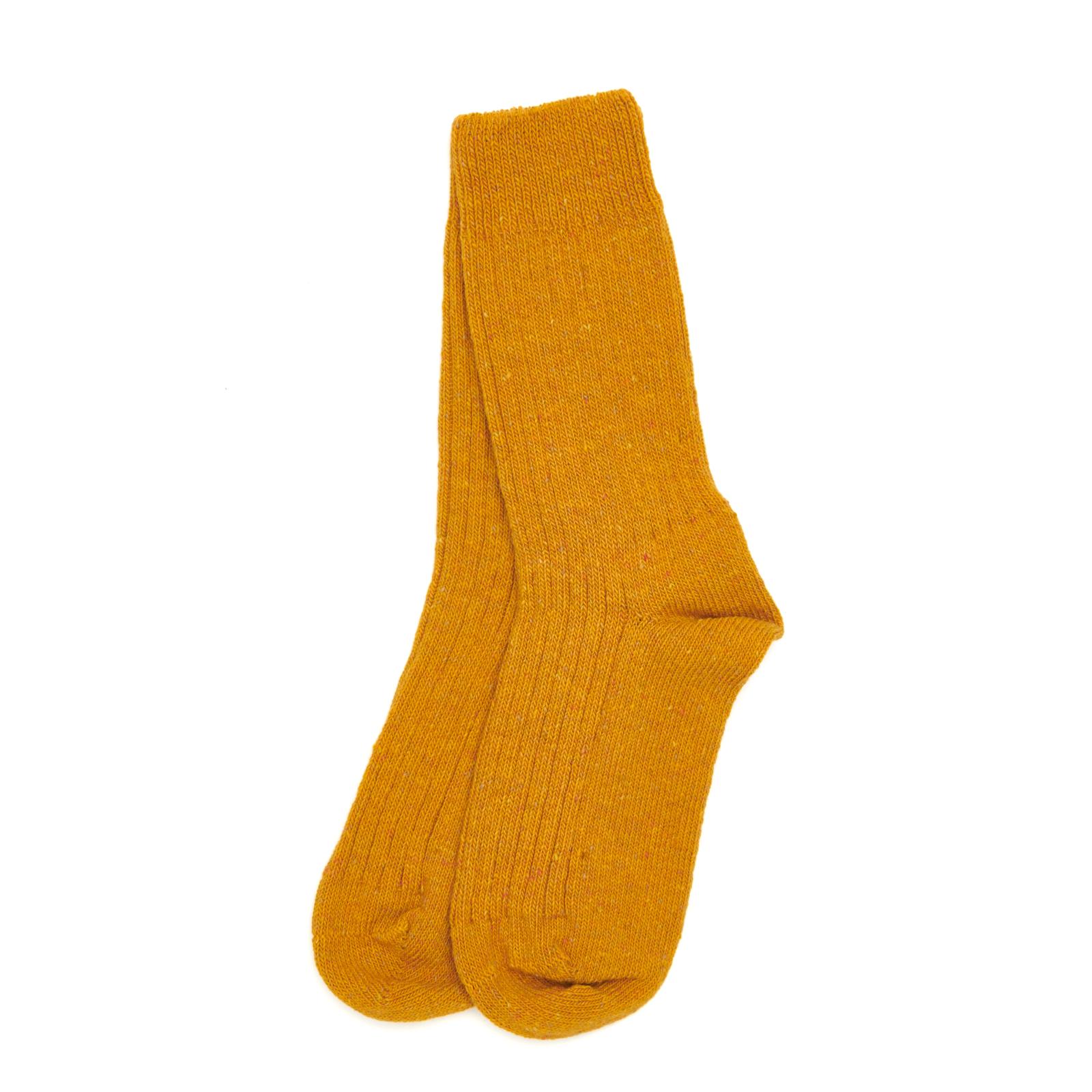 A pair of mustard yellow ribbed merino wool boot socks folded on a white background.