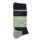 A packaged pair of navy and grey merino wool crew socks in a printed luxury merino socks band.