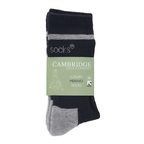 A packaged pair of navy and grey merino wool crew socks in a printed luxury merino socks band.