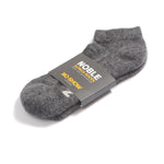 Grey Noble alpaca no-show sock with a Noble paper band
